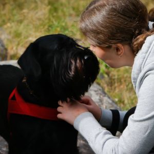 Svart hund tillsammans med sin matte